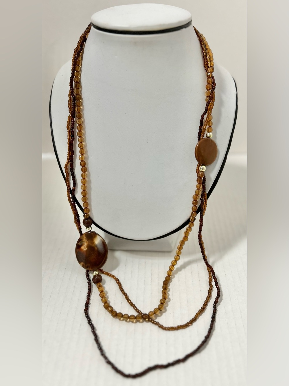 Autumn-toned bead necklace multi-strand featuring brown and amber-colored beads